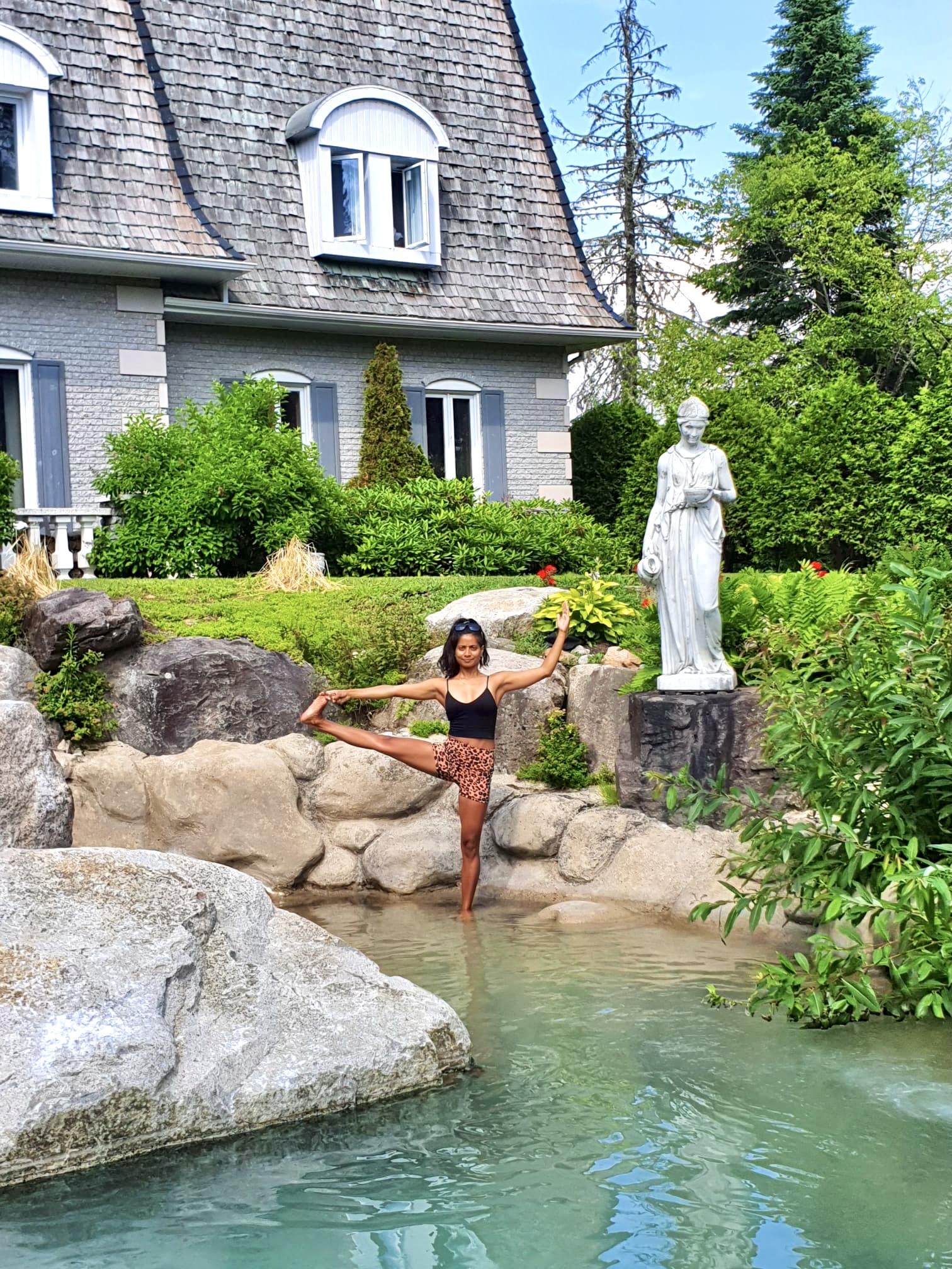 woman doing yoga pose in pond